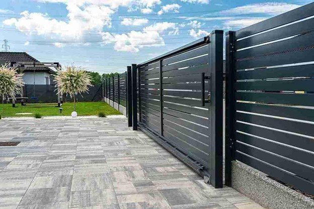 Contemporary horizontal metal sliding gate installed along a residential driveway with clean lines and durable construction.