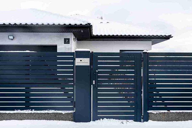 Modern metal sliding gate installed in front of a residential property, showing smooth alignment and secure entry design.